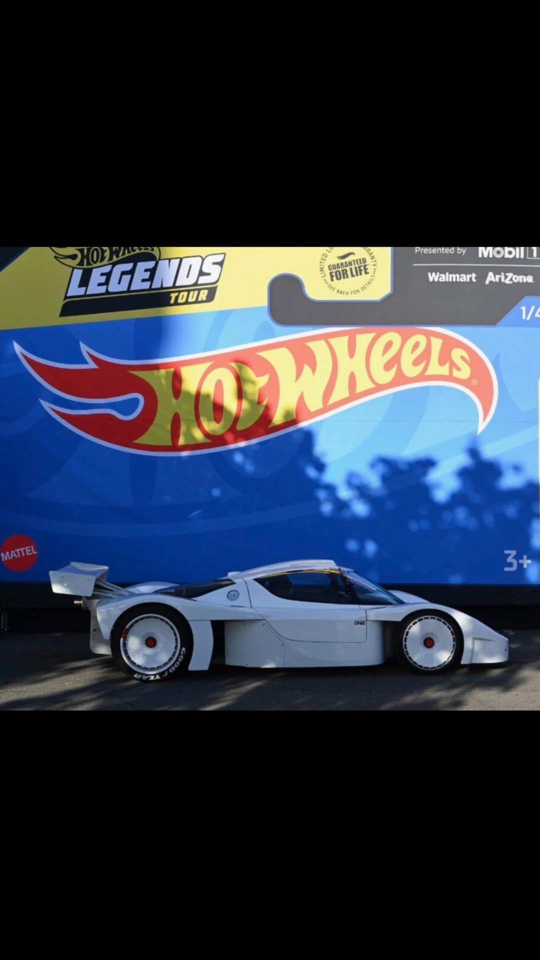 Rob Mesa's white track-built sports car in front of the Hot Wheels Legends Tour backdrop