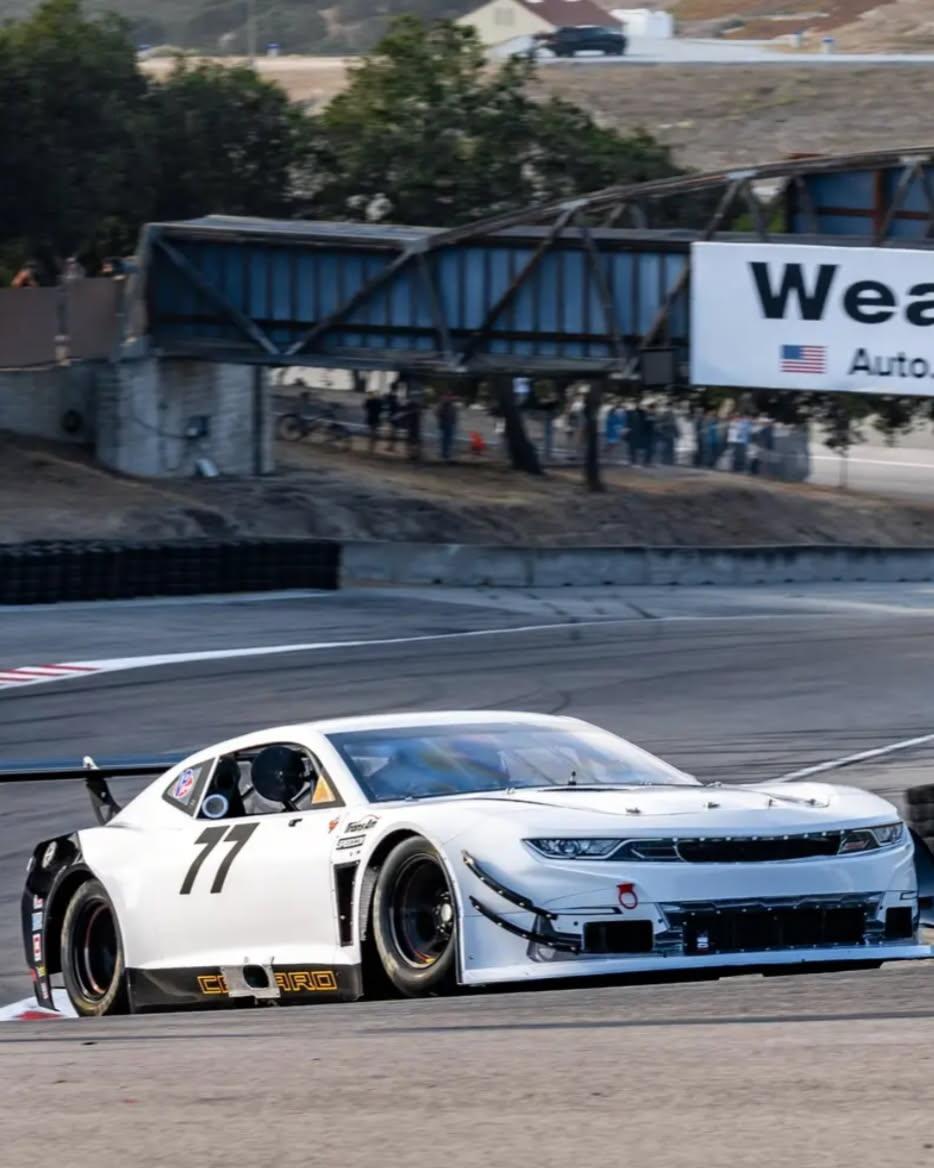 Jeff Leaver's #77 white Camaro race car on track at Laguna Seca